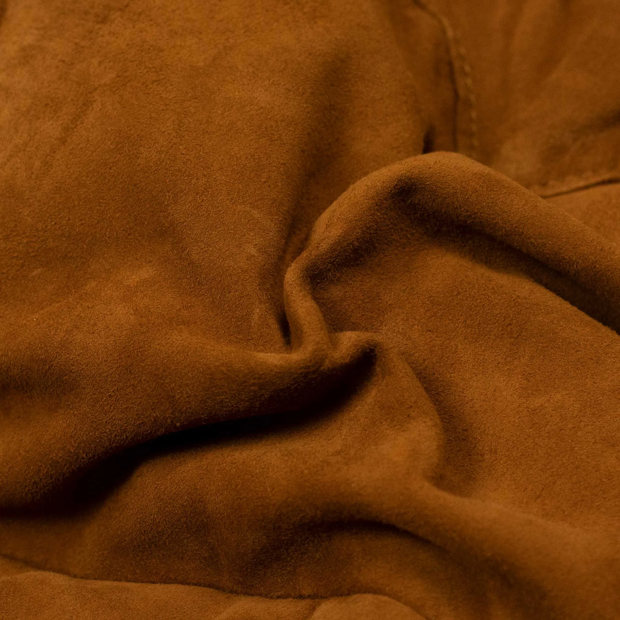 Down-filled vest in tan suede